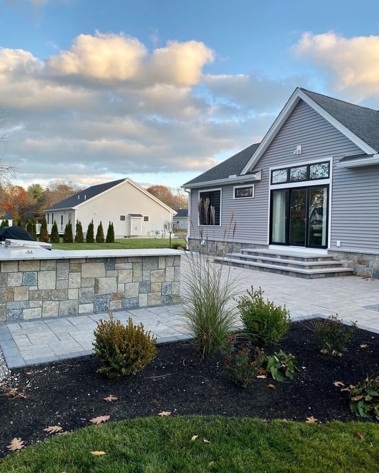 Outdoor living patio with natural stone outdoor kitchen.