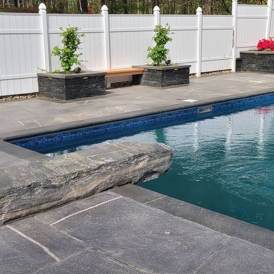 Pool design with natural stone dive rock