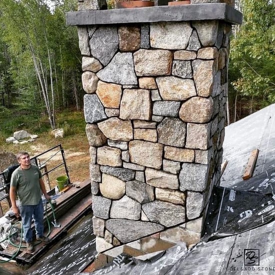 Chimney covered with natural stone veneer