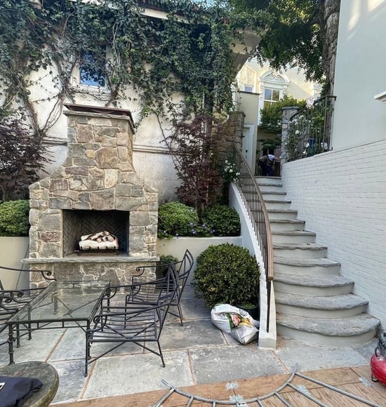 Outdoor fireplace featuring natural stone