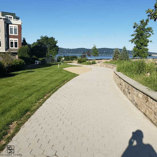 Outdoor walkway with natural stone wall in new development