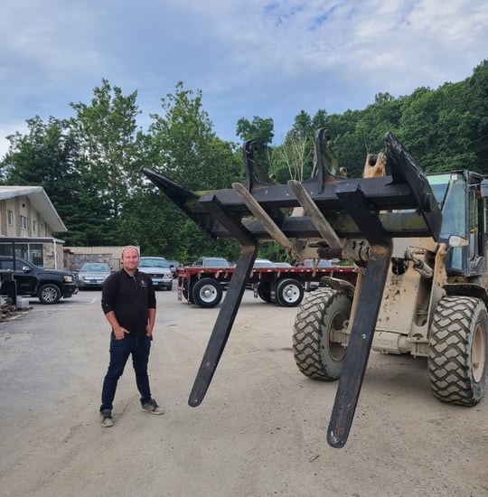 Tyler with stone loader in Delgado Stone driveway